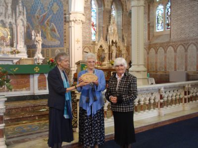 Catherine Brennan SSL, chairperson of Eco-Congregation Ireland, presents an award to Frances Carey and Bernie O'Raw