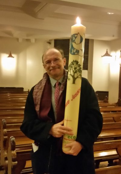 Pastor Martin Sauter with ECI's climate justice candle